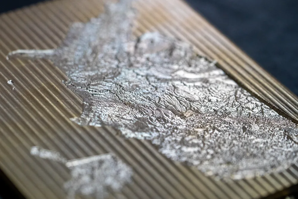 Low side profile of the United States embossing die showing its physical terrain depth
