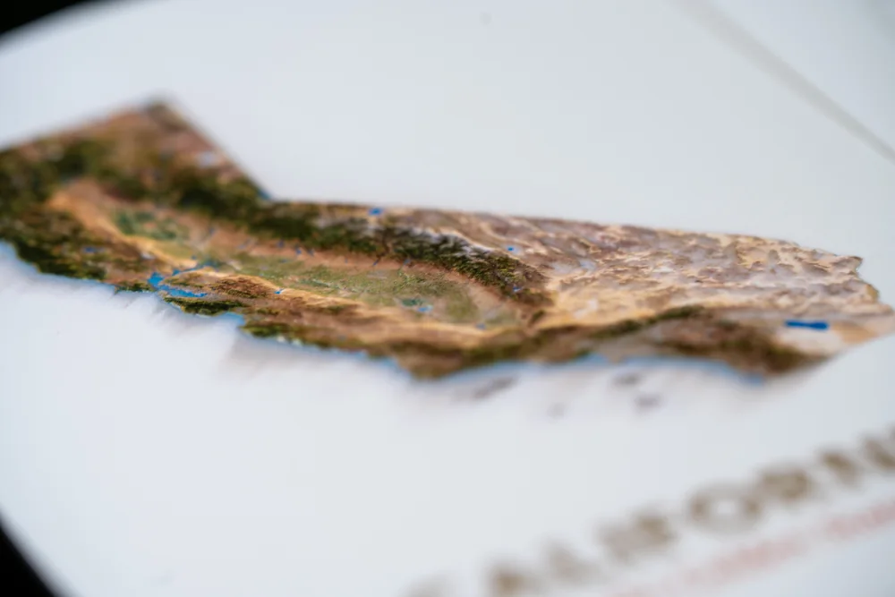 Edge-on close-up showing the thickness and raised relief of a United States postcard production proof